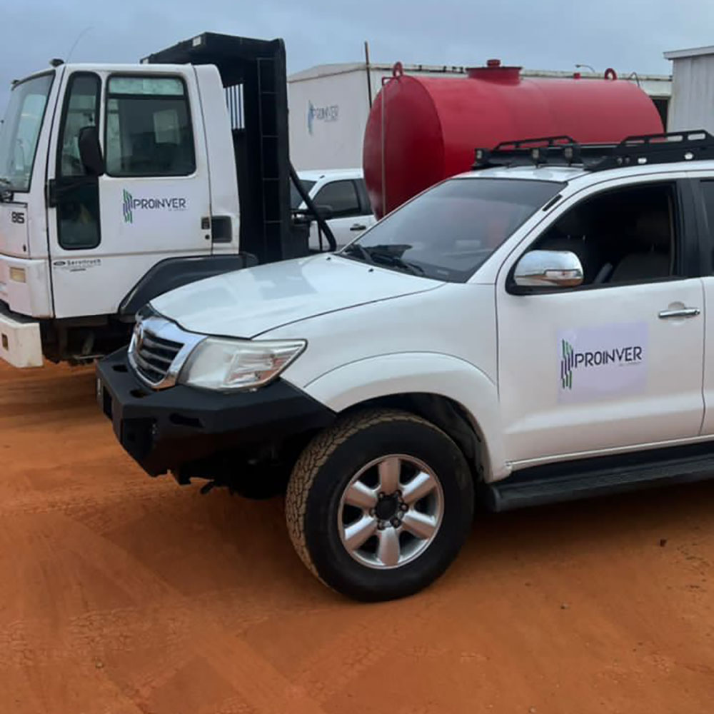 A pickup truck and a truck displaying the ProInver brand in an outdoor area.